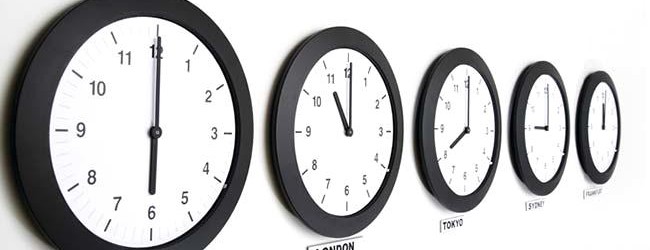 Wall clocks in line displaying international time
